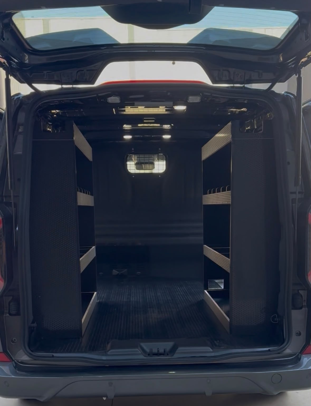Dual-side shelving system for a tradie van